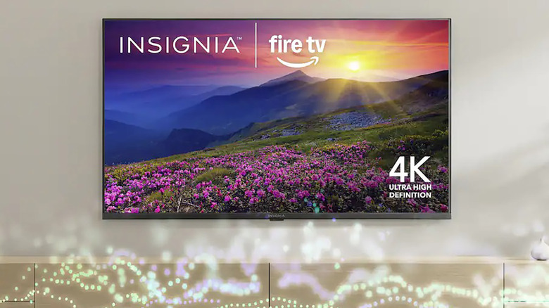 An Insignia Fire TV mounted on a wall.