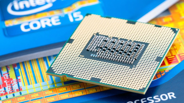 A closeup of an Intel CPU on a backdrop of Intel packaging
