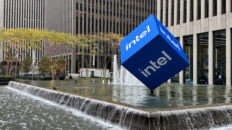 A photo of the outside of an Intel corporate building featuring a cube in a fountain with the company's branding