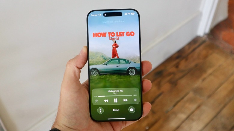 iOS 26 new Lock Screen with animated Apple Music album cover