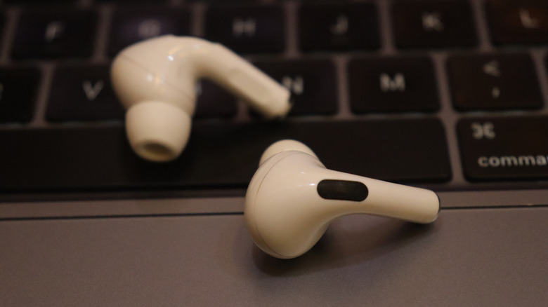 AirPods Pro wireless earphones on top of a MacBook.