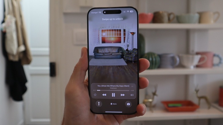 iOS 26 Lock Screen with music playing on iPhone 16 Pro Max