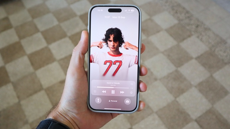 iOS 26 new Lock Screen with Apple Music album cover