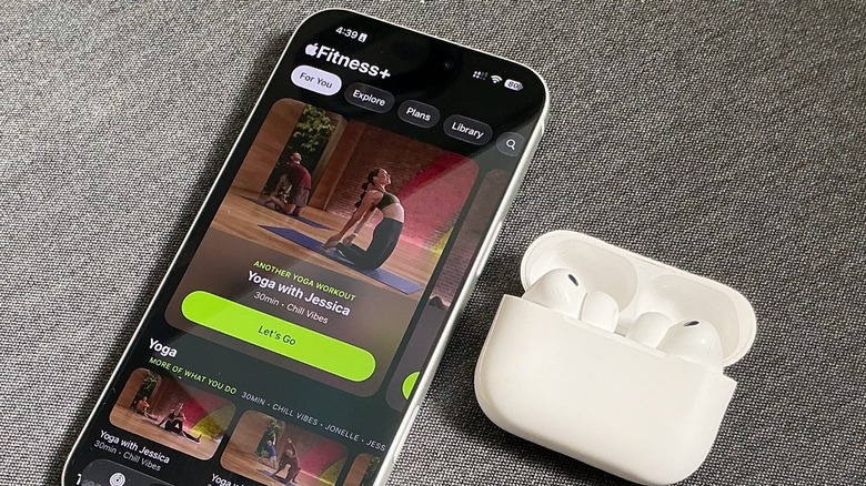 A close-up shot of iPhone and AirPods Pro 3 near each other