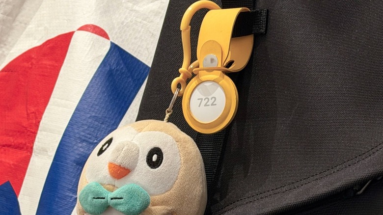 Close-up shot at Apple's AirTag attached to a backpack with a Pokémon plush