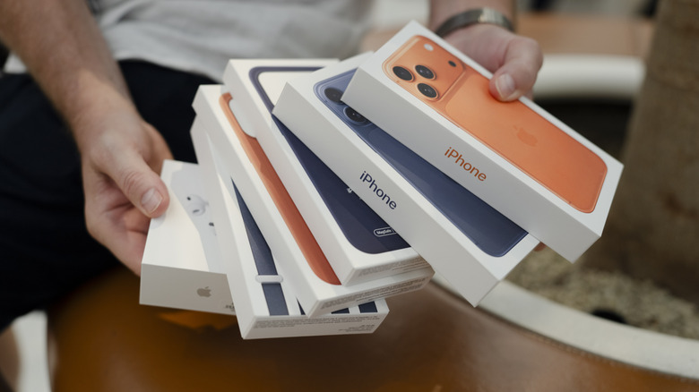 iPhone 17 retail boxes and accessories in hand