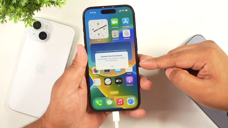 An iPhone showing the "attached accessory uses too much power" error when connected to a thumb drive.