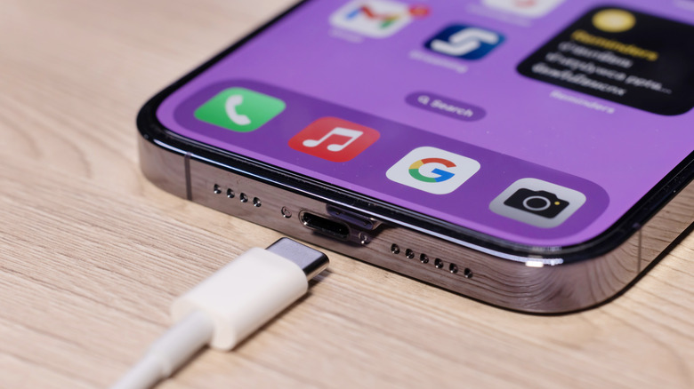 An iPhone's USB-C port in view, with an USB-C cable sloe to it.