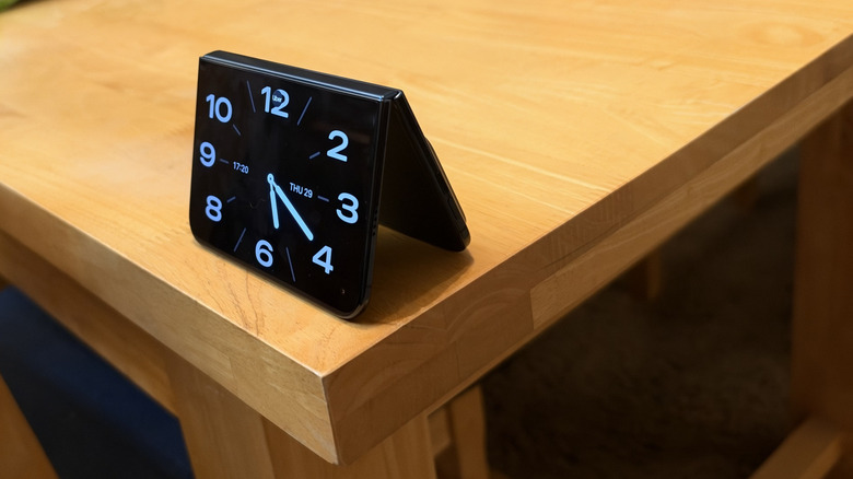 iPhone Duo running the clock widget in StandBy on a desk
