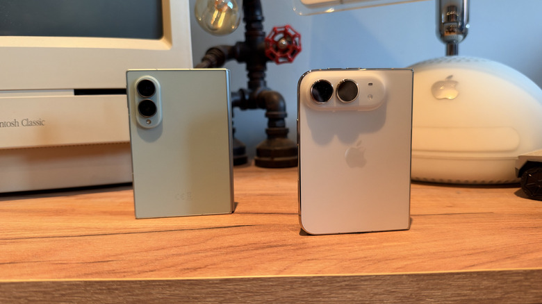 iPhone Duo and Samsung Galaxy Fold 8 stood on a desk, folded with their rear panels showing
