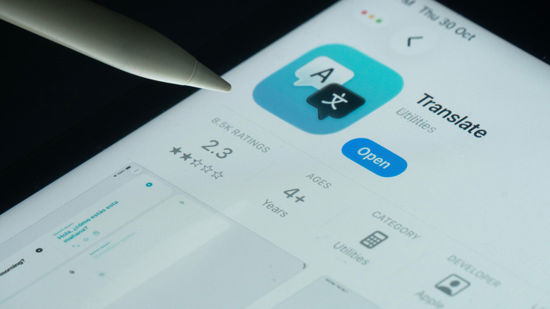 Apple's Translate app open on an iPad with an apple pencil hovering over the ratings