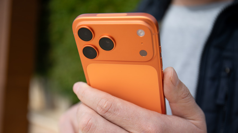 person holding orange iphone