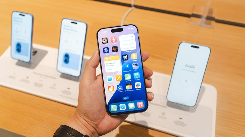 A photograph of a hand holding an iPhone.