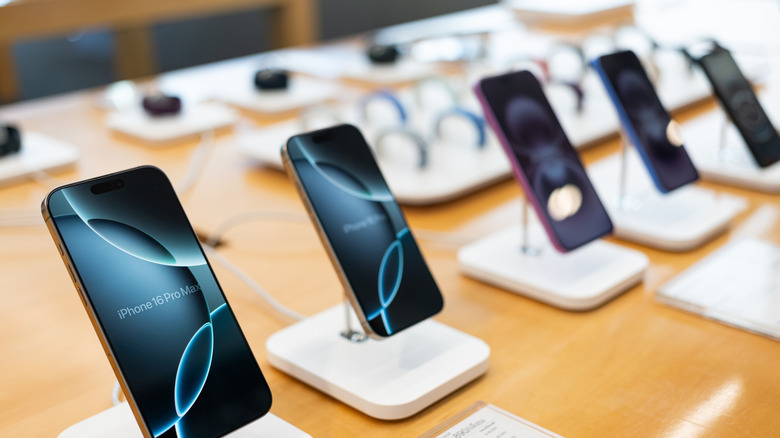 A row of iPhone models in a store
