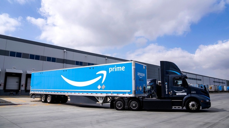 Amazon delivery truck sitting outside warehouse