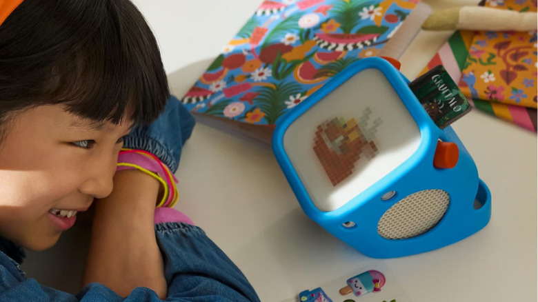 A child listening to audio with the Yoto Player speaker