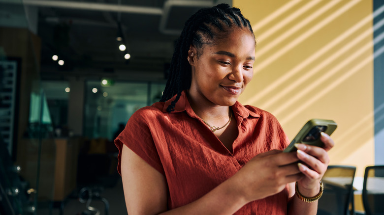 Woman using smartphone in restaurant