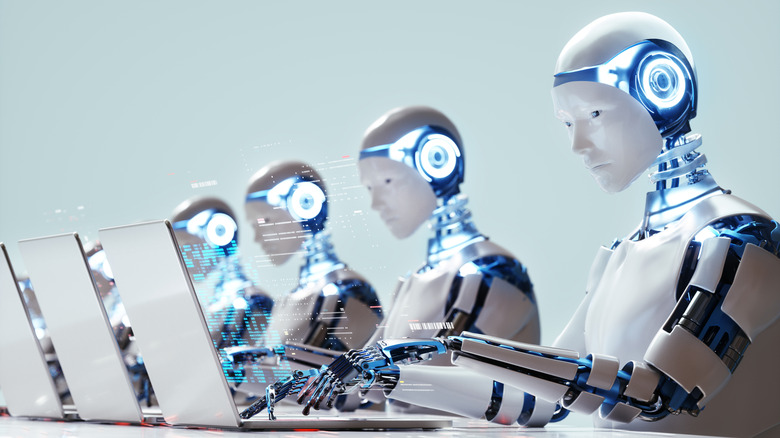 Multiple robots working on laptops