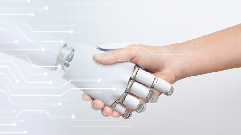 Robot hand shaking a human hand