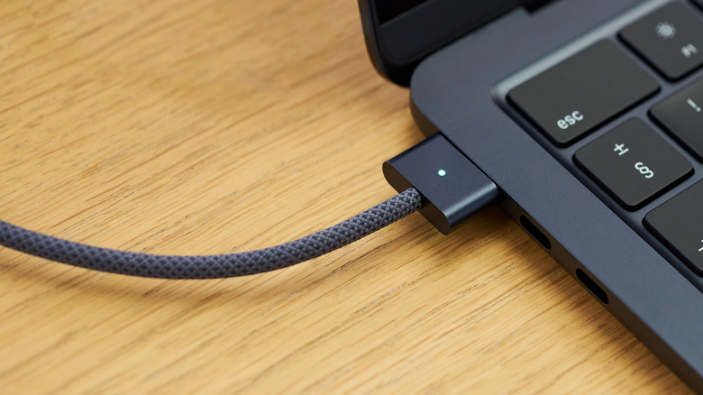 Close-up of Apple's braided charging cable connected to a MacBook Air