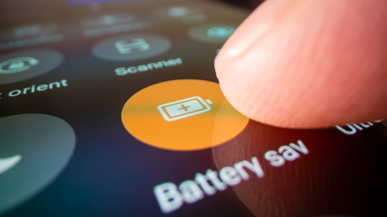 a finger tapping the battery saver button on an Android phone
