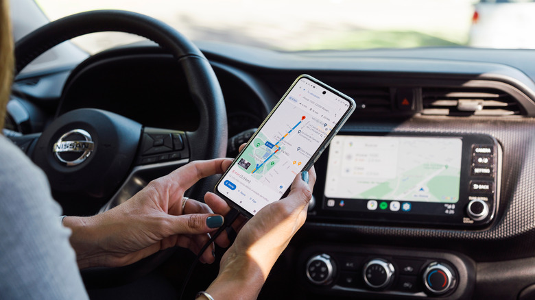 Someone holding their phone with Google Maps app on screen.
