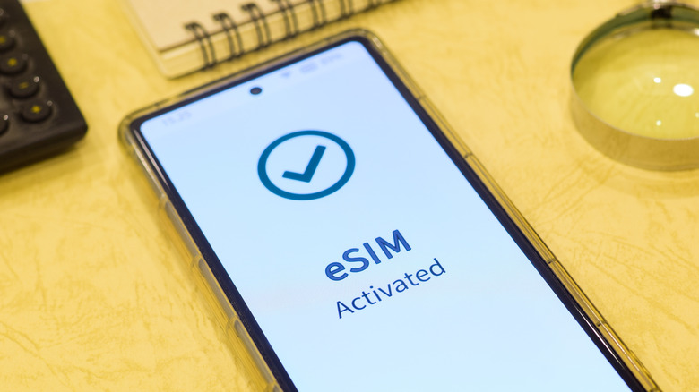 A smartphone displays an activation screen for an eSIM.