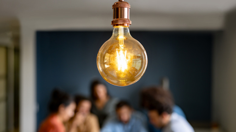 A group of people leave the light on in a bright room