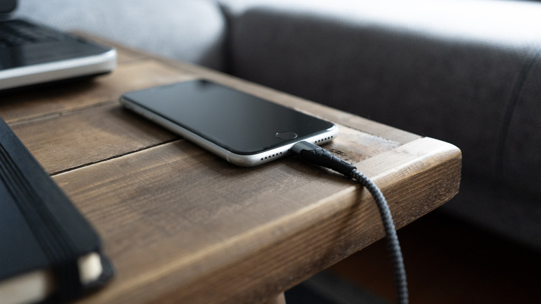A phone being charged on a table
