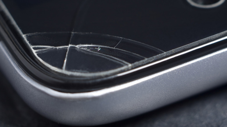Damage shown on the corner of a smartphone's screen protector.