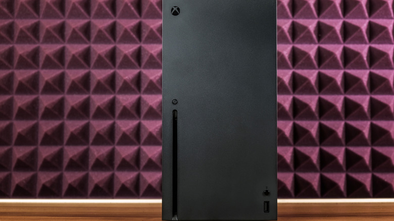 Xbox Series X with a textured burgundy background