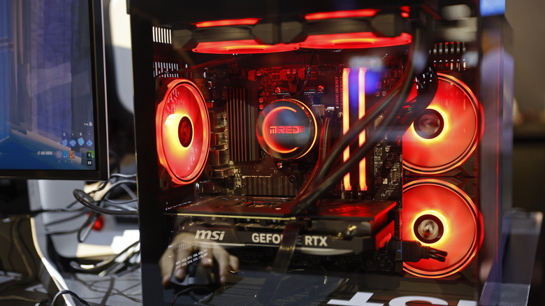 A MSI GeForce RTX graphics card lit with orange lights.