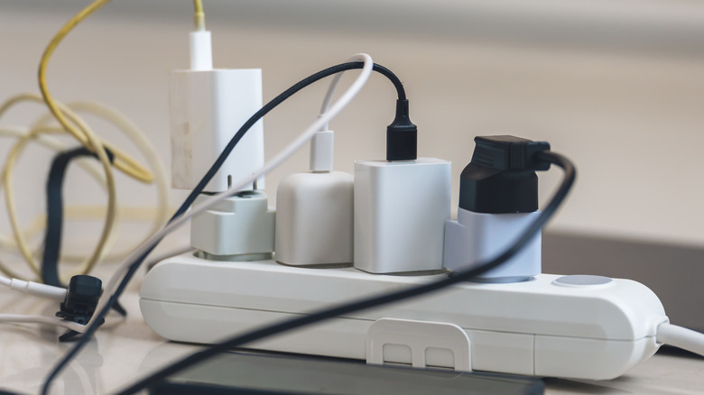 Various USB chargers plugged into an electrical outlet.