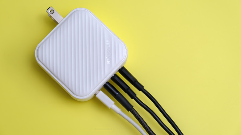 GAN power adapter with multiple USB cables plugged in.