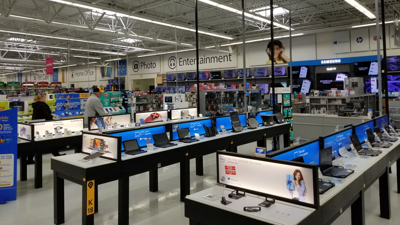 An assortment of laptops and computers on display in a Walmart store