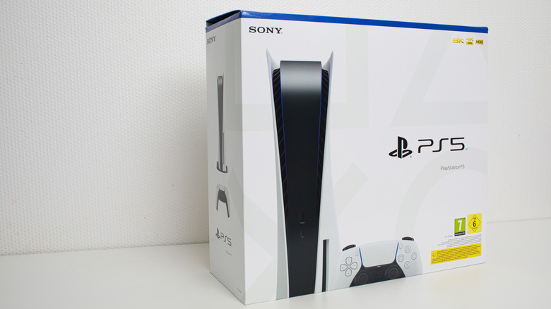 PlayStation 5 inside its retail box next to a white wall