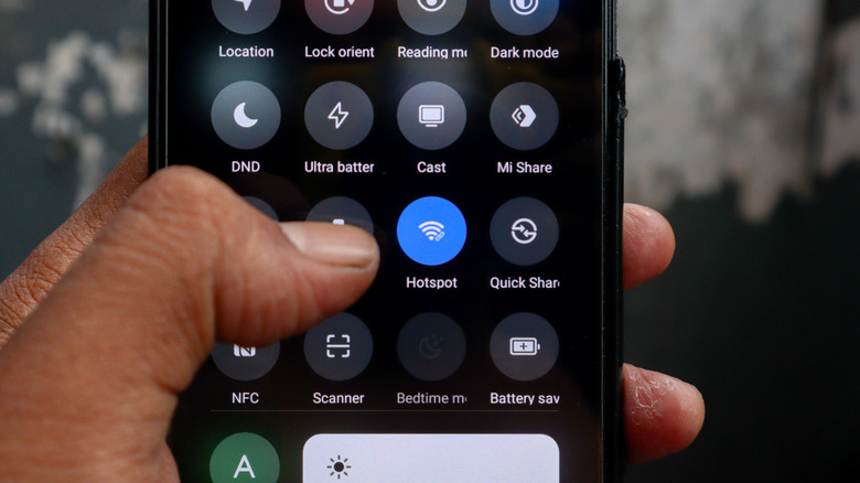 Person holding an Android smartphone turning on hotspot