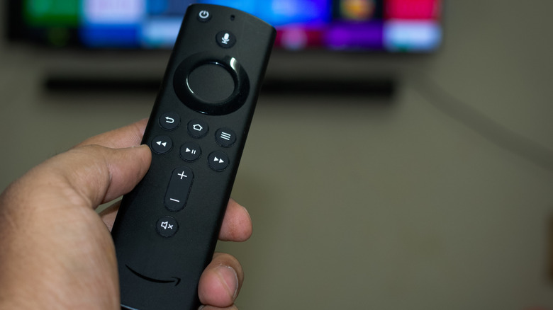 a hand holding an Amazon Fire TV Remote