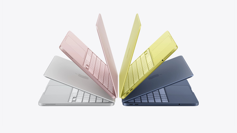 Group of MacBook Neo laptops fanned out in different colorways.