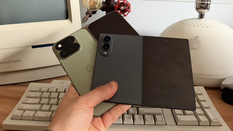 Google Pixel 11 Pro Fold and Samsung Galaxy Fold 8 being held in one hand with screens unfolded