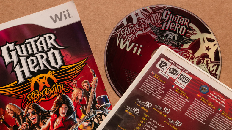 Wii copy of Guitar Hero video game with disc sitting outside the case
