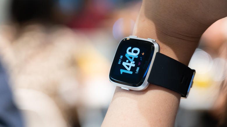 Someone wearing a Fitbit Versa on their wrist
