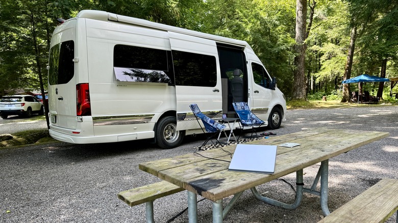 A campervan with a Starlink Mini on a picnic table