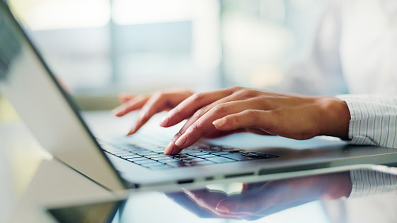 Person typing on a laptop.