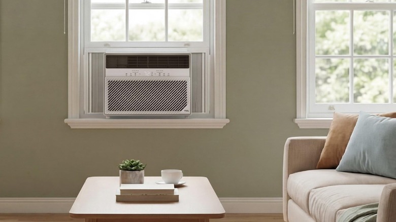 The TCL 14,000 BTU E-Series Smart Inverter Window Air Conditioner mounted in a living room.