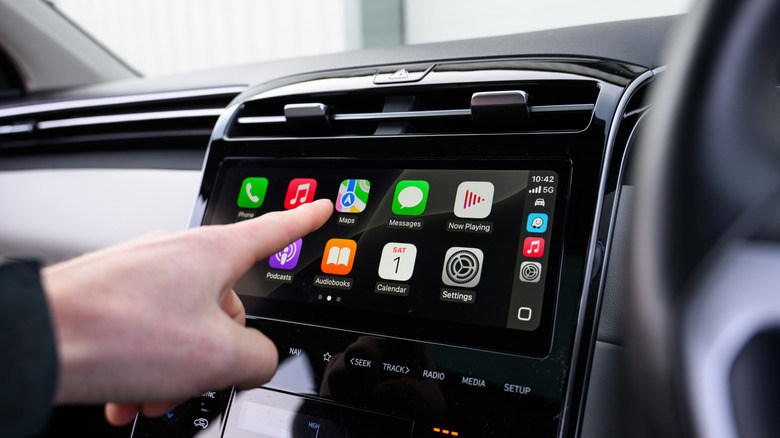 Driver Using Apple CarPlay on Touchscreen