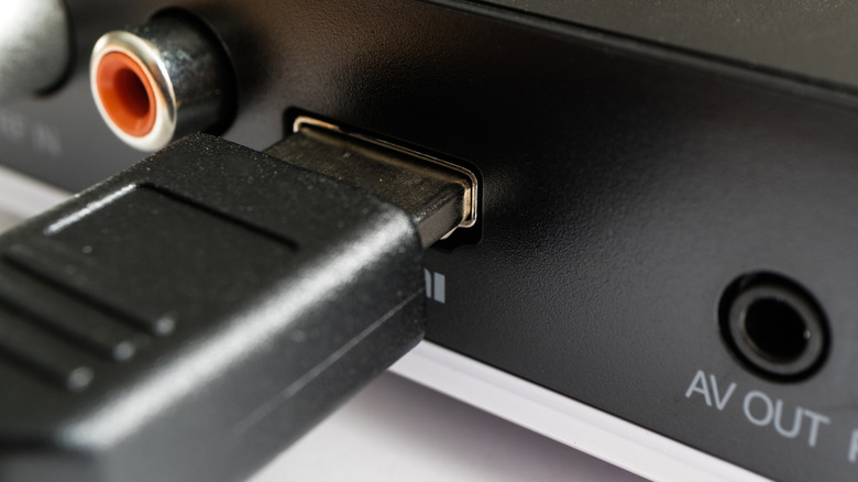 HDMI connector plugging into DVD player for a wired connection.
