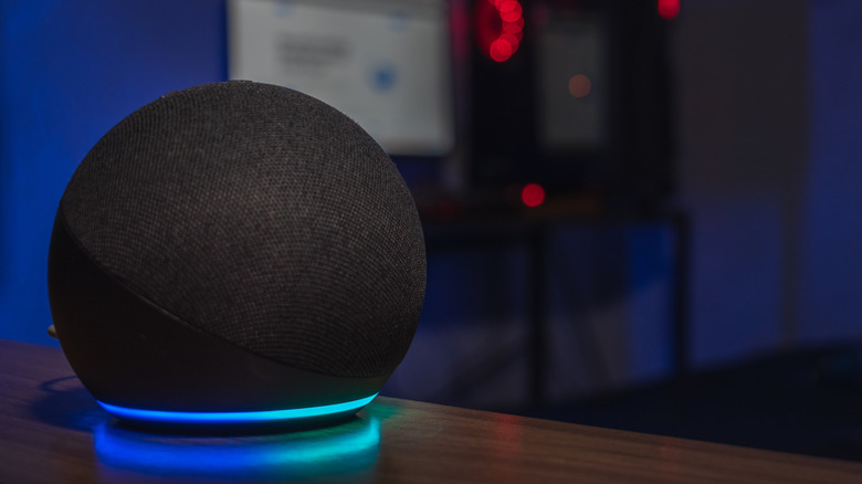 An Amazon Echo Dot speaker on a table.