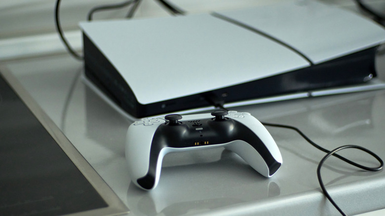 A PlayStation 5 and DualSense controller placed on a shelf.