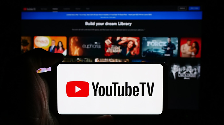 YouTube TV on a smart phone with a TV in the background